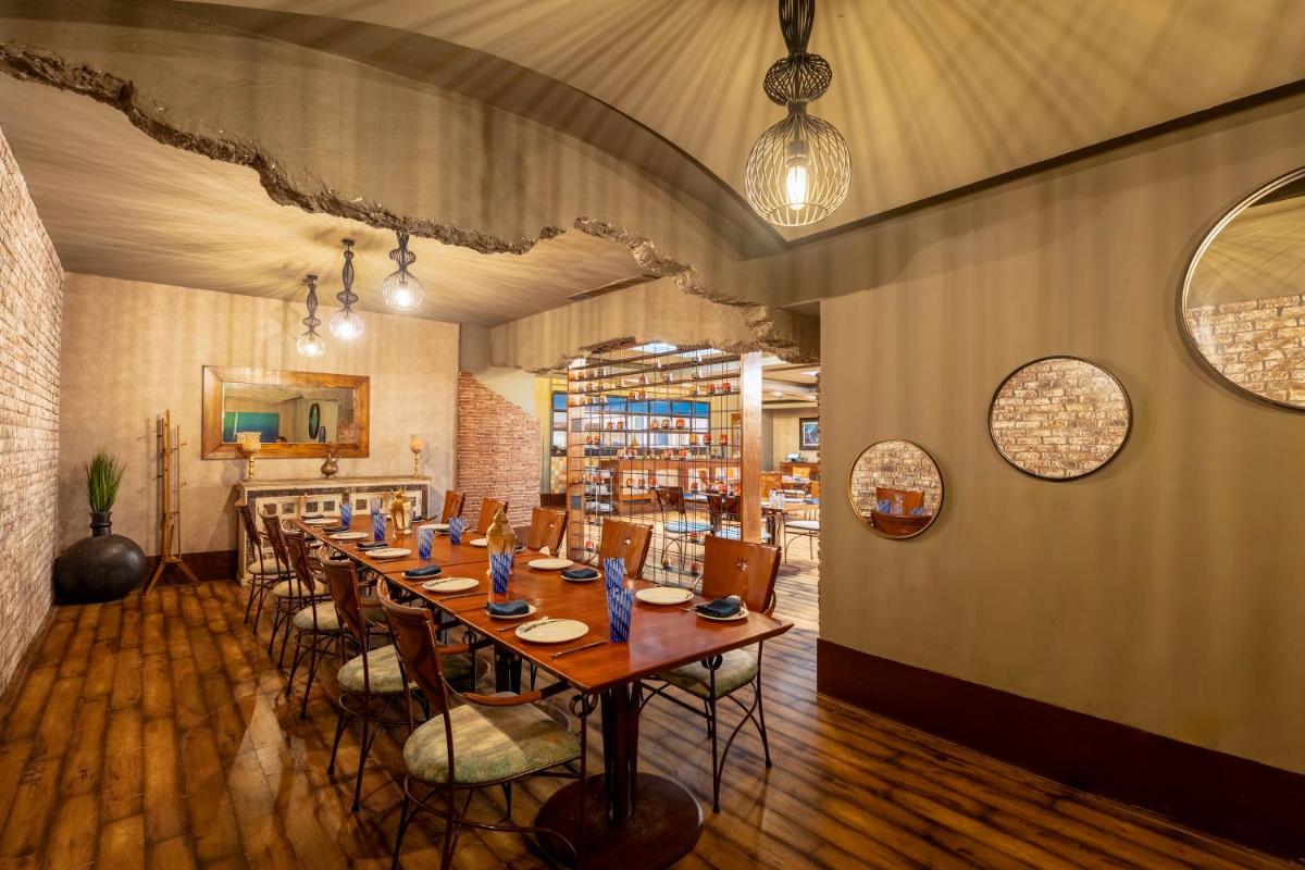 a dining room with a long table and chairs at Radisson Blu Hotel Pune Kharadi in Pune