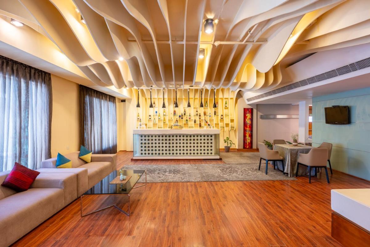 a living room with a couch and a fireplace at Radisson Blu Hotel Pune Kharadi in Pune