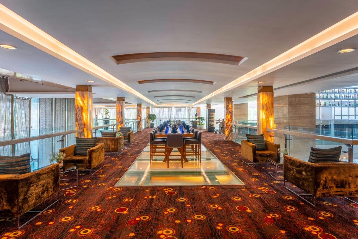 a hotel lobby with a table and chairs at Radisson Blu Hotel Pune Kharadi in Pune