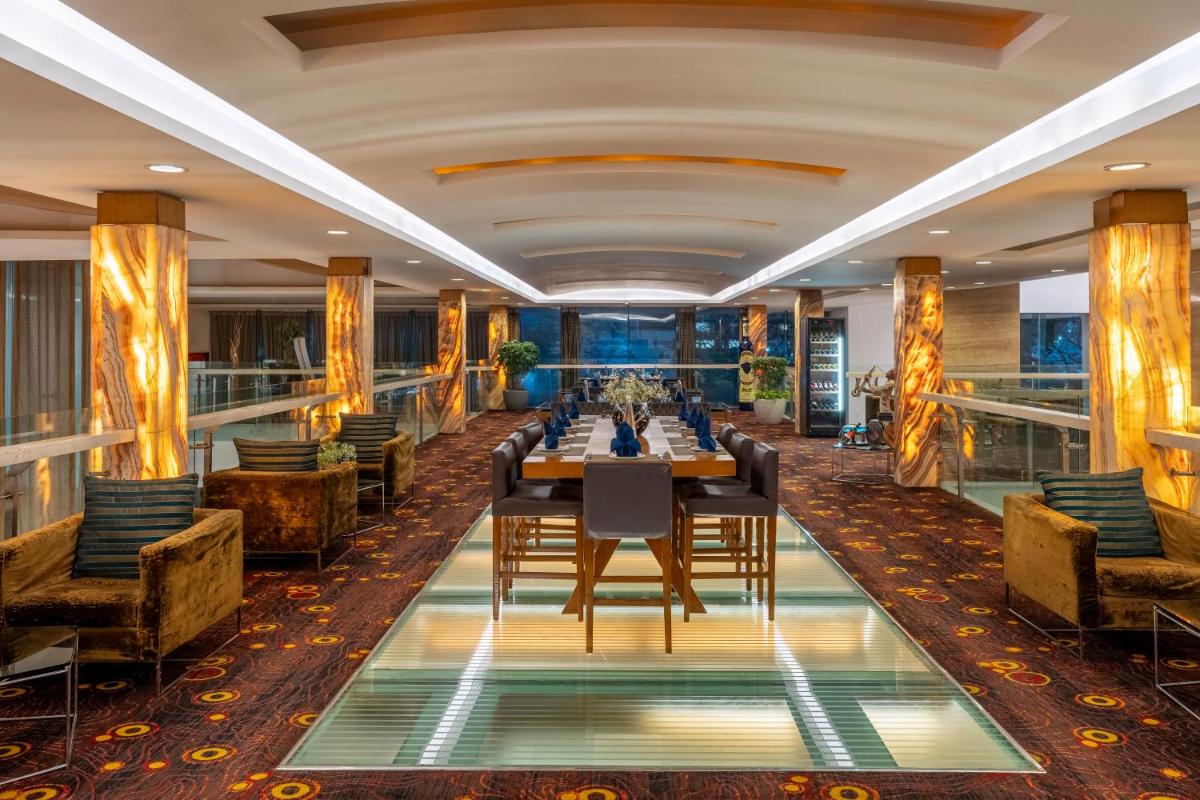 a dining room with a long table and chairs at Radisson Blu Hotel Pune Kharadi in Pune