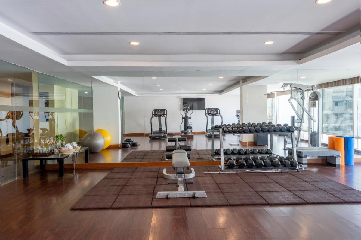 a gym with several treadmills and exercise equipment at Radisson Blu Hotel Pune Kharadi in Pune
