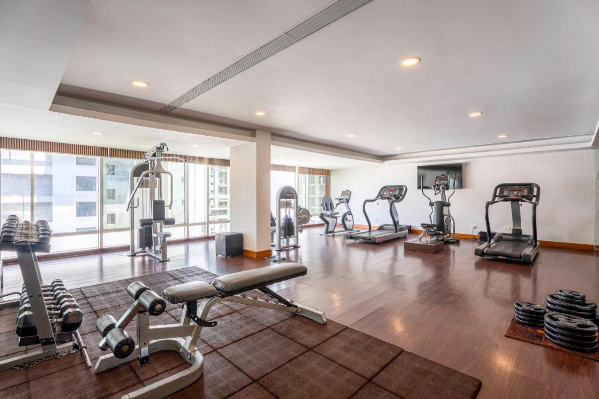 a gym with several treadmills and exercise machines at Radisson Blu Hotel Pune Kharadi in Pune