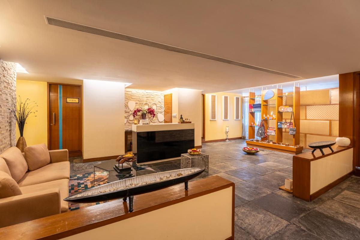 a living room with a couch and a fireplace at Radisson Blu Hotel Pune Kharadi in Pune