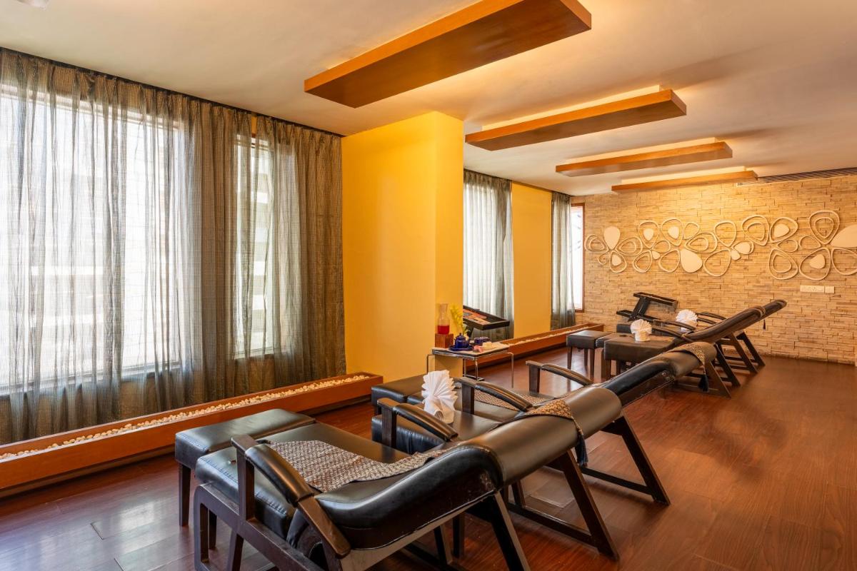 a hair salon with leather chairs and a barber shop at Radisson Blu Hotel Pune Kharadi in Pune