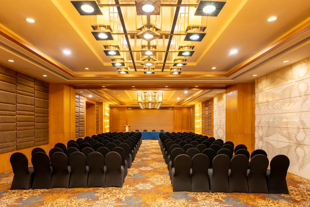 a conference room with black chairs in the middle at Radisson Blu Hotel Pune Kharadi in Pune +129 photos