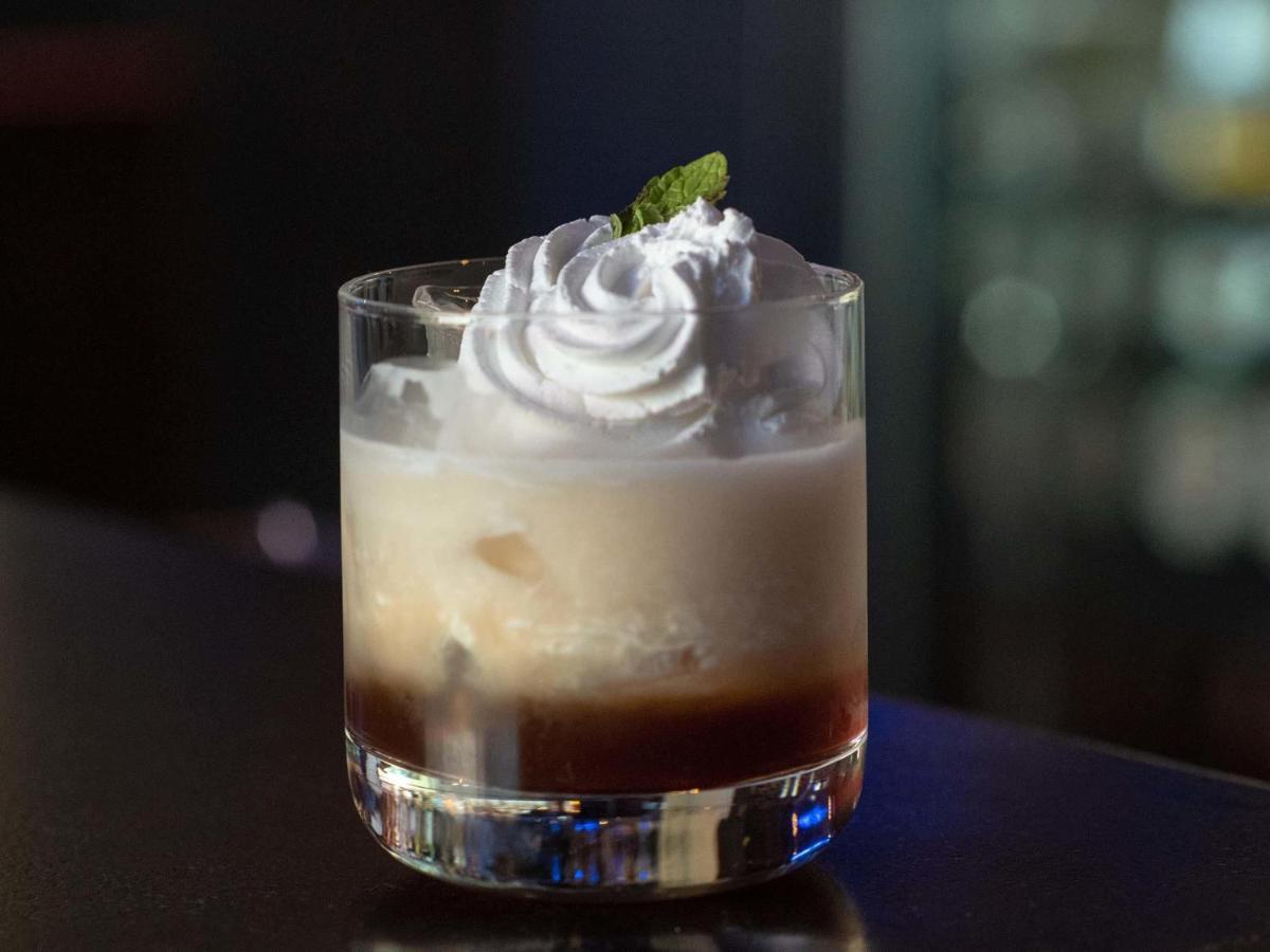 a drink with whipped cream and a mint leaf on top at Mercure Hyderabad KCP Banjara Hills, An Accor Hotel in Hyderabad