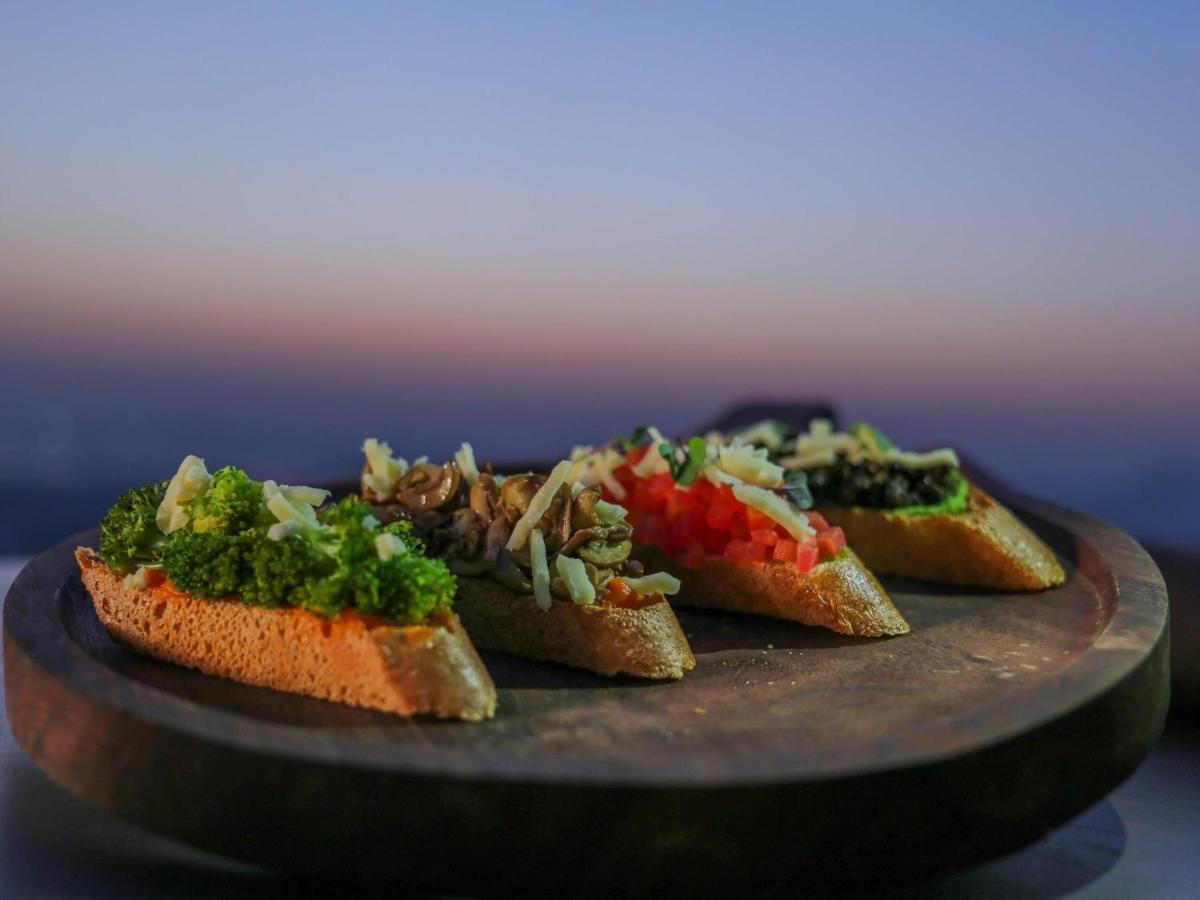 a plate with four pieces of bread with vegetables on it at Mercure Hyderabad KCP Banjara Hills, An Accor Hotel in Hyderabad