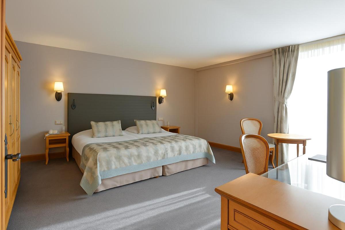 Un ou plusieurs lits dans un hébergement de l'établissement Hôtel Golf Château de Chailly
