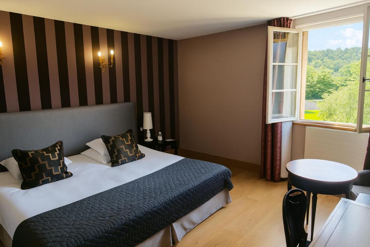 Un ou plusieurs lits dans un hébergement de l'établissement Hôtel Golf Château de Chailly