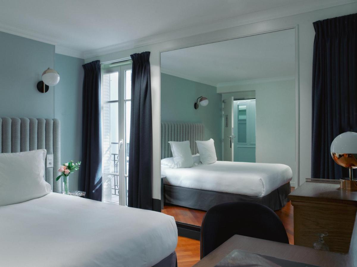 Un ou plusieurs lits dans un hébergement de l'établissement Hotel Bachaumont