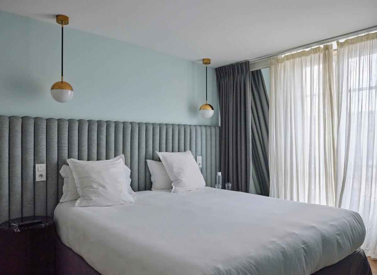 Un ou plusieurs lits dans un hébergement de l'établissement Hotel Bachaumont