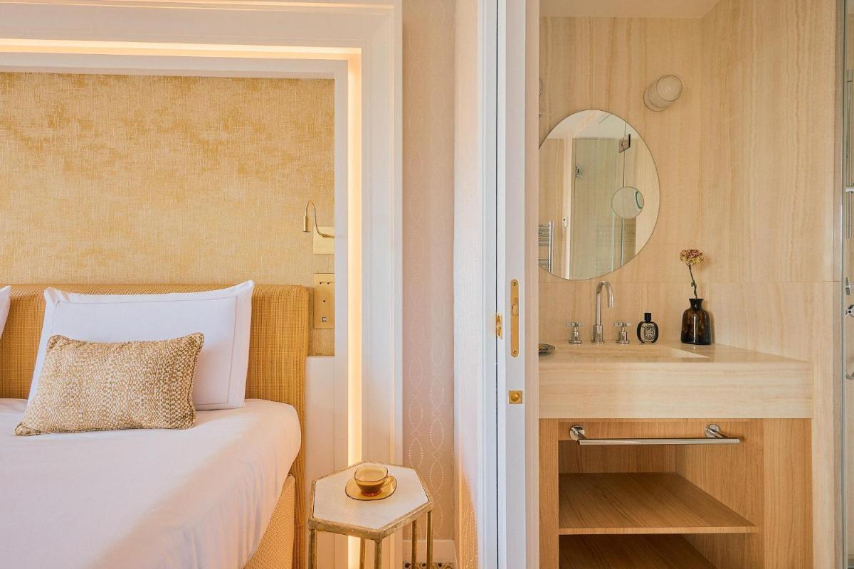 Un ou plusieurs lits dans un hébergement de l'établissement Hôtel Madison