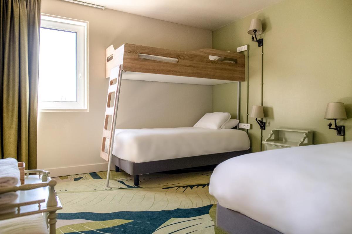 Un ou plusieurs lits dans un hébergement de l'établissement Hotel Mercure Parc du Coudray - Barbizon