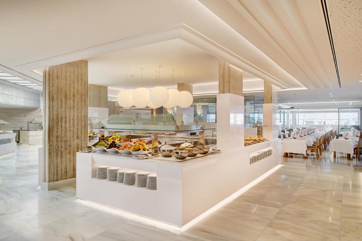 Un buffet en un restaurante con comida en exhibición. en Hipotels Mediterraneo Hotel - Adults Only, en Sa Coma