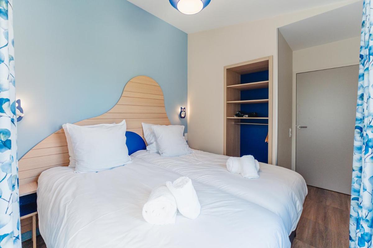 Cama o camas de una habitación en Center Parcs Villages Nature Paris