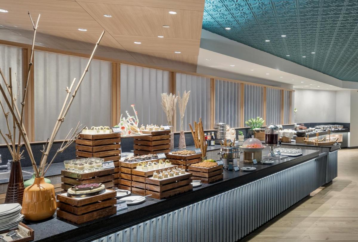 a buffet line with cakes and other food on display at The Park Chennai in Chennai