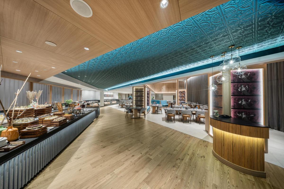a restaurant with a blue ceiling and wooden floors at The Park Chennai in Chennai