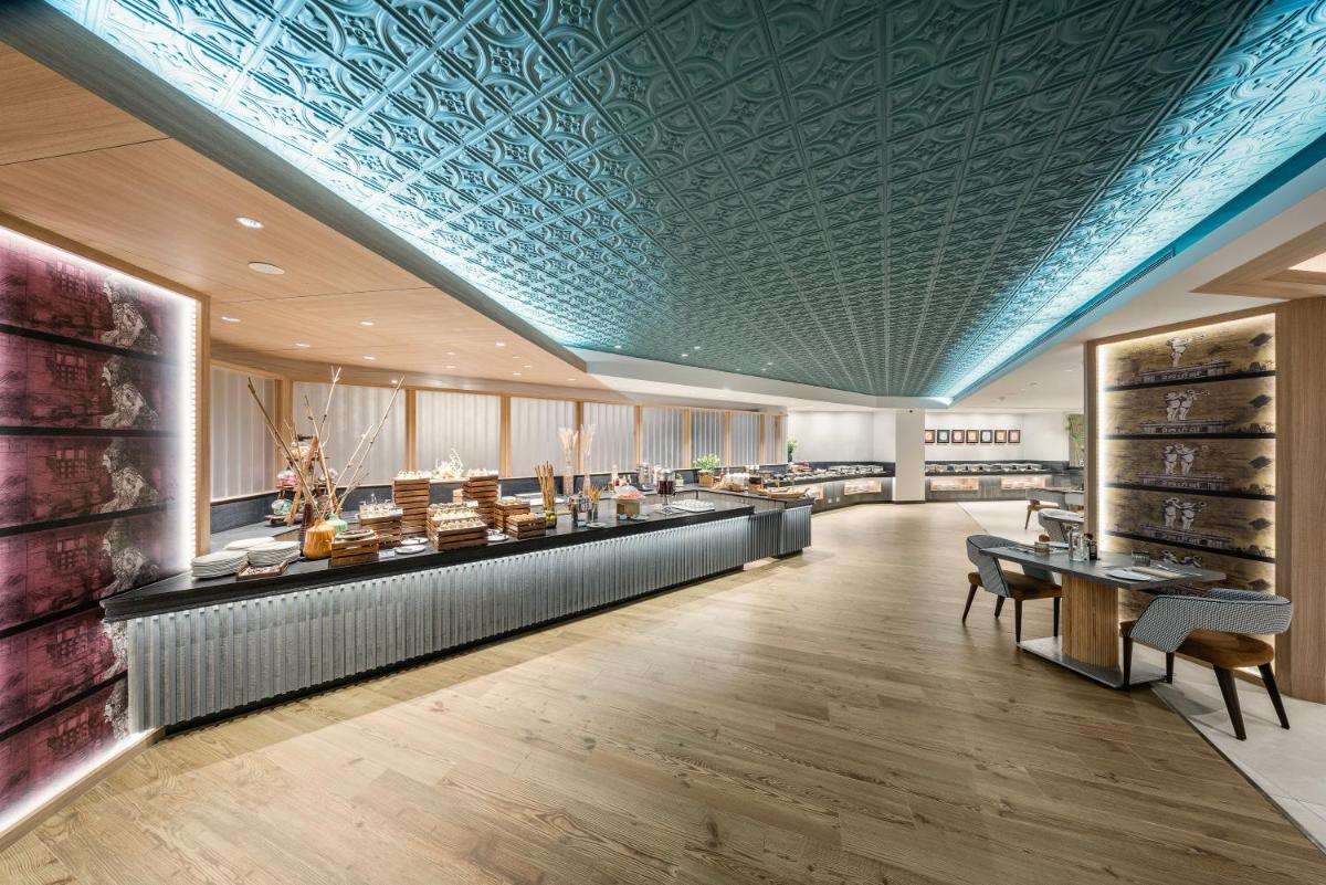 a store with a blue ceiling and a room with tables at The Park Chennai in Chennai