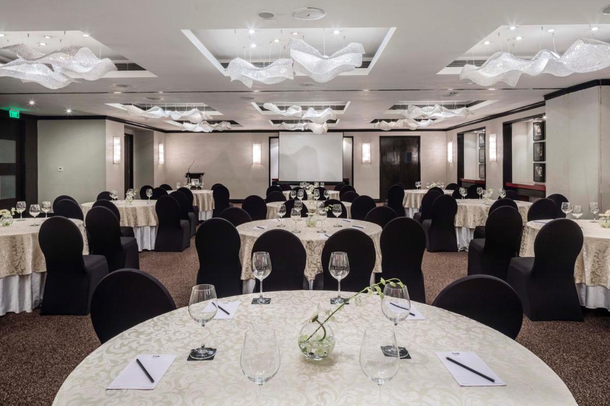 a conference room with tables and chairs with wine glasses at The Park Chennai in Chennai