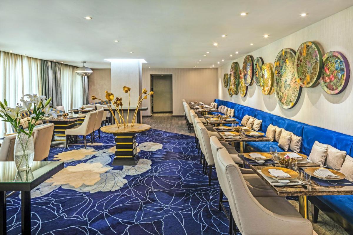 a dining room with long tables and chairs at The Park Chennai in Chennai