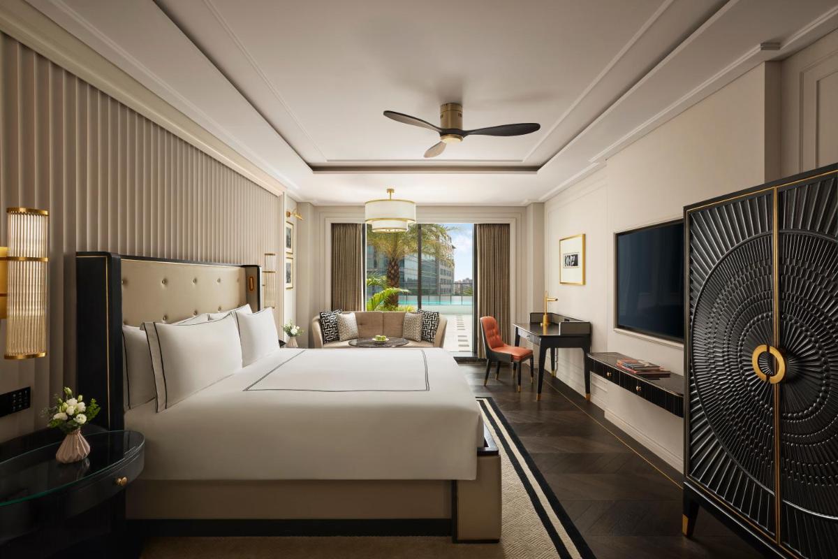 a hotel room with a bed and a desk at Fairmont Mumbai in Mumbai