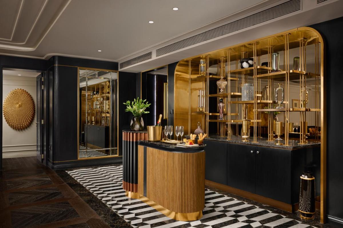 a lobby with a bar with glass shelves at Fairmont Mumbai in Mumbai