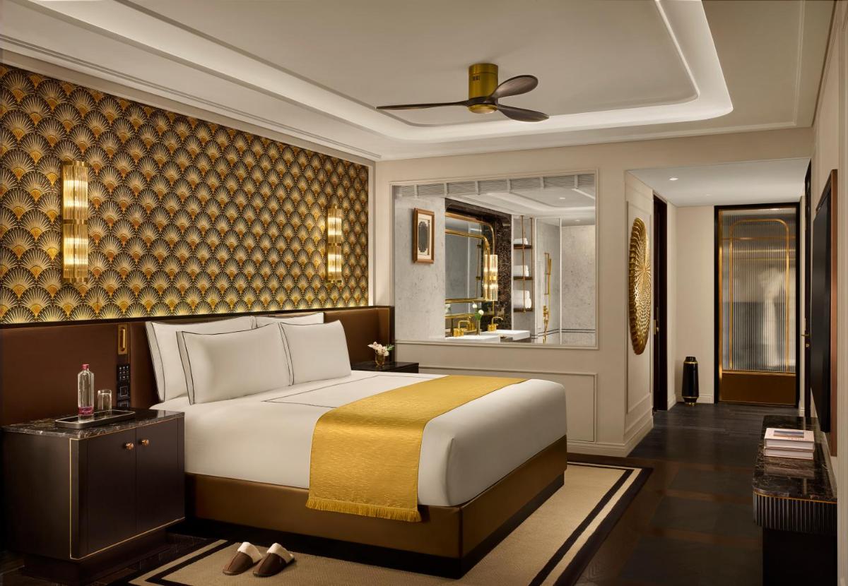 a bedroom with a large bed in a room at Fairmont Mumbai in Mumbai