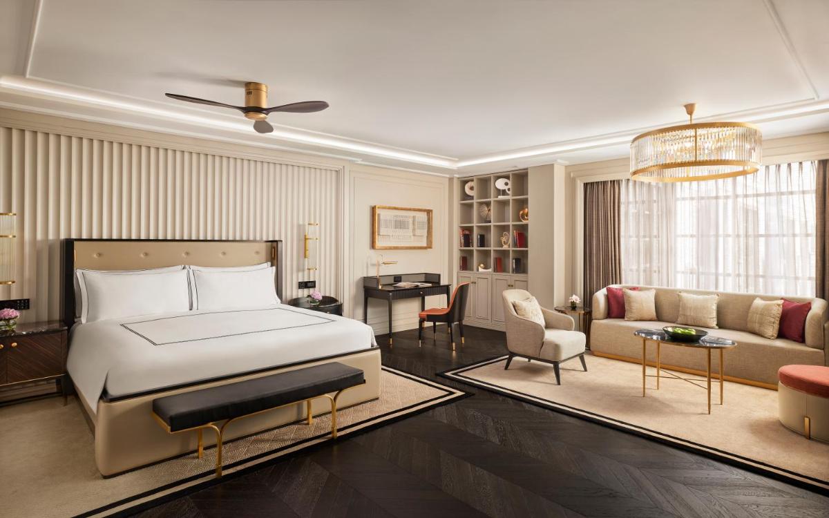 a bedroom with a bed and a living room at Fairmont Mumbai in Mumbai