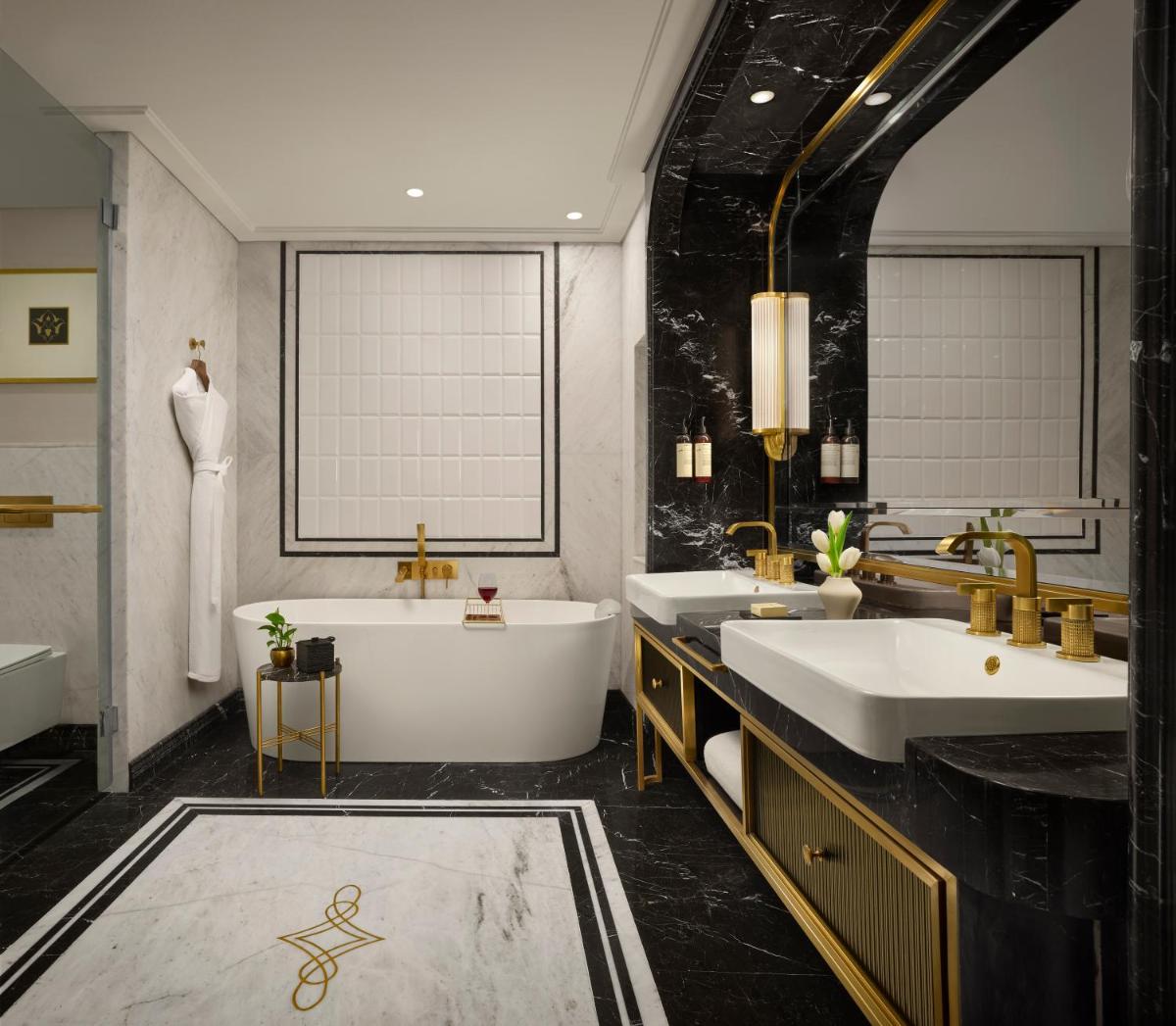 a bathroom with two sinks and a bath tub at Fairmont Mumbai in Mumbai
