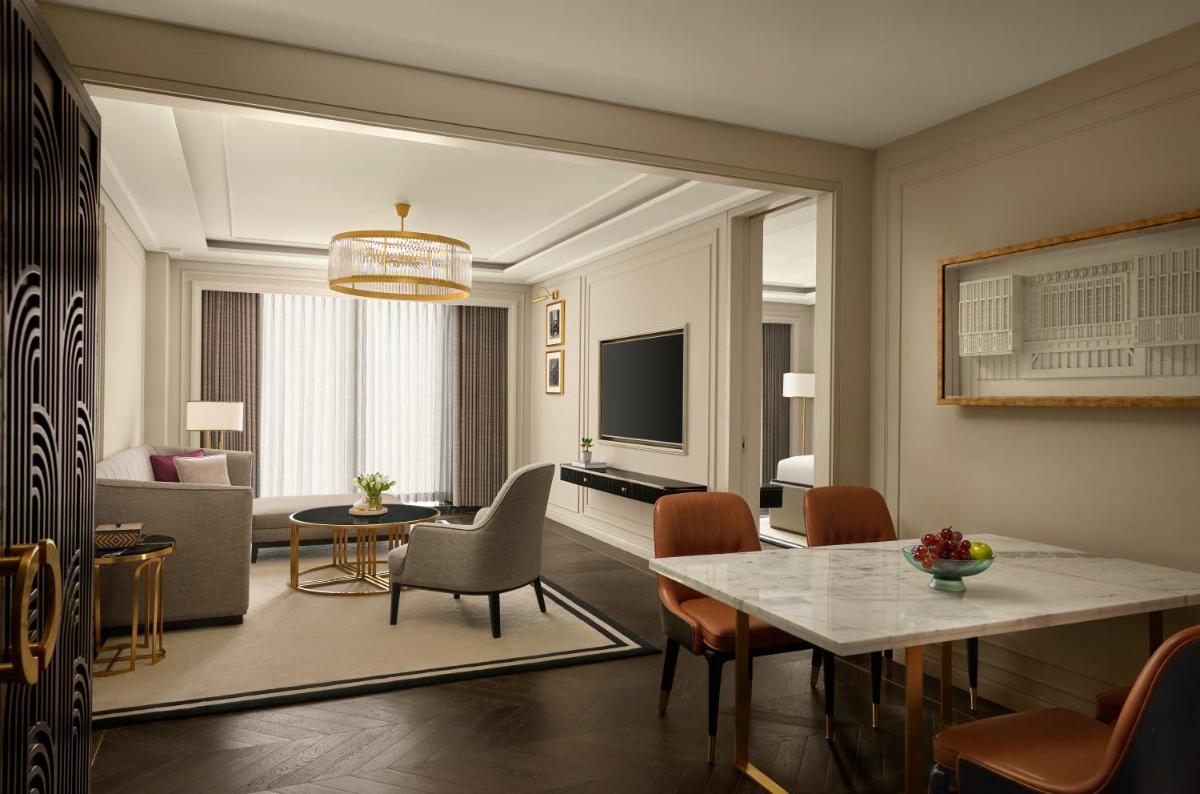 a living room with a dining table and a living room at Fairmont Mumbai in Mumbai
