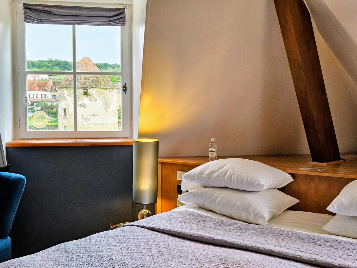 Un ou plusieurs lits dans un hébergement de l'établissement Hôtel Golf Château de Chailly