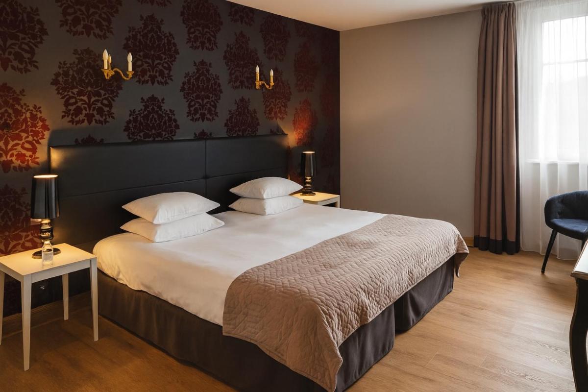 Un ou plusieurs lits dans un hébergement de l'établissement Hôtel Golf Château de Chailly
