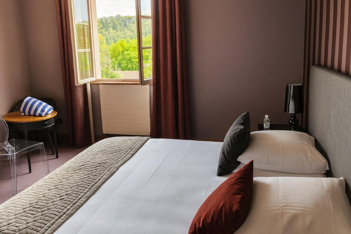 Un ou plusieurs lits dans un hébergement de l'établissement Hôtel Golf Château de Chailly