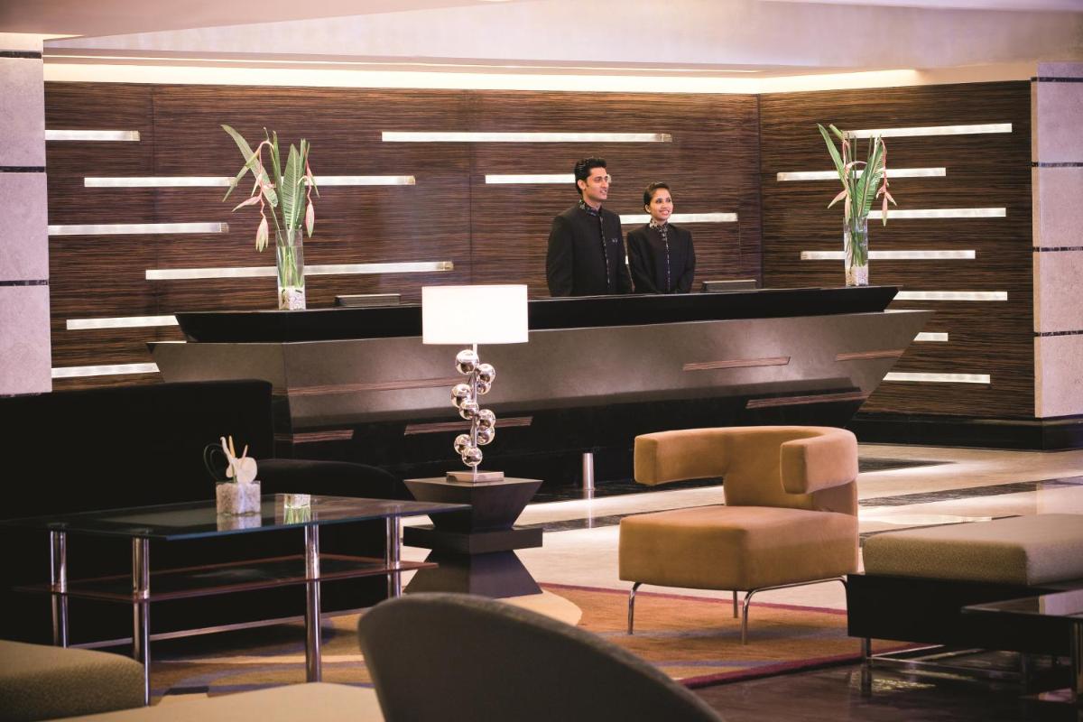 two men standing at a piano in a living room at Gokulam Grand Hotel & Spa Bangalore in Bengaluru +92 photos two men standing at a piano in a living room at Gokulam Grand Hotel & Spa Bangalore in Bengaluru +92 photos