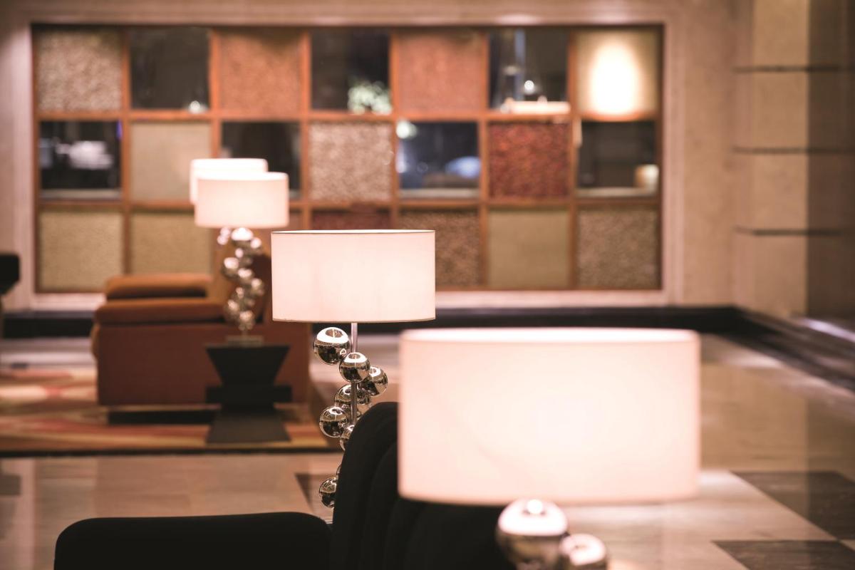 two lamps on a table in a living room at Gokulam Grand Hotel & Spa Bangalore in Bengaluru two lamps on a table in a living room at Gokulam Grand Hotel & Spa Bangalore in Bengaluru