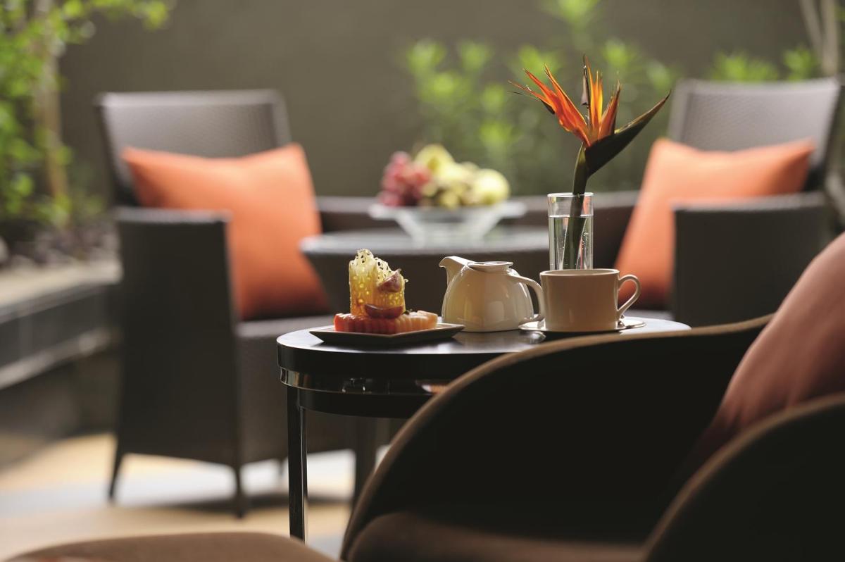 a table with a plate of food on top at Gokulam Grand Hotel & Spa Bangalore in Bengaluru a table with a plate of food on top at Gokulam Grand Hotel & Spa Bangalore in Bengaluru