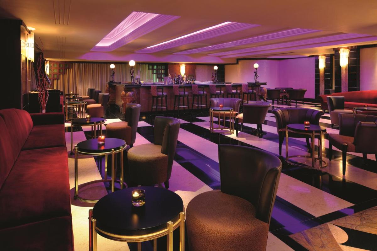 a restaurant with tables and chairs and a bar at Gokulam Grand Hotel & Spa Bangalore in Bengaluru a restaurant with tables and chairs and a bar at Gokulam Grand Hotel & Spa Bangalore in Bengaluru