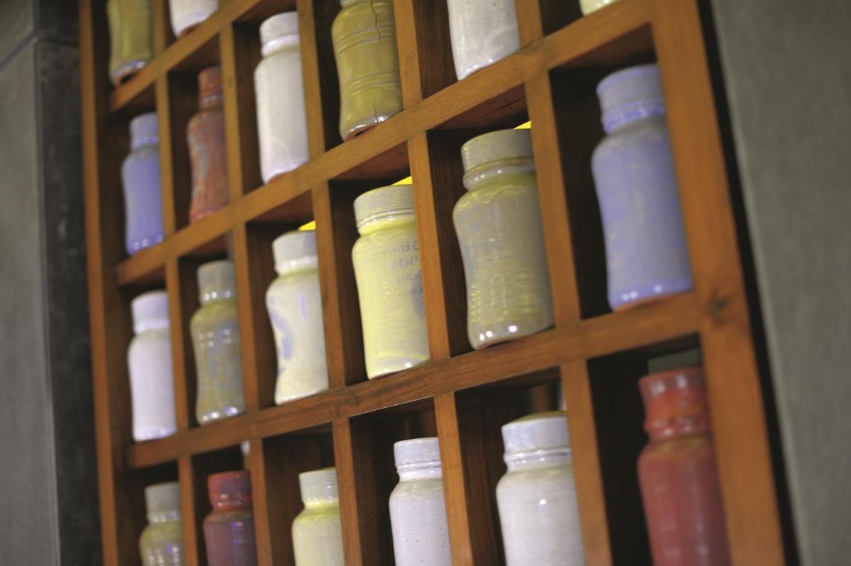 a wooden door with a bunch of different colored jars at Gokulam Grand Hotel & Spa Bangalore in Bengaluru a wooden door with a bunch of different colored jars at Gokulam Grand Hotel & Spa Bangalore in Bengaluru