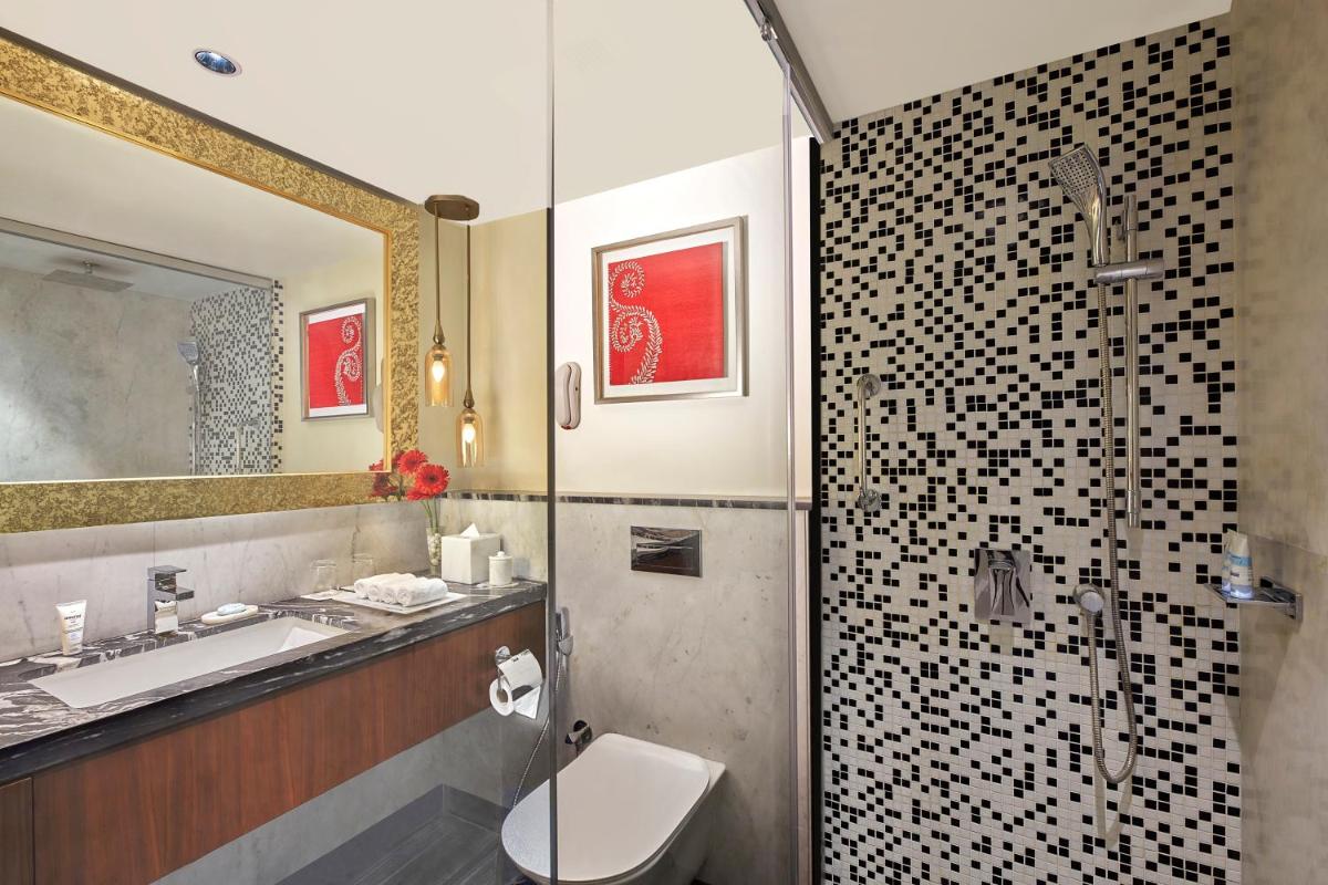 a bathroom with a toilet and a sink and a shower at ITC Kakatiya, a Luxury Collection Hotel, Hyderabad in Hyderabad