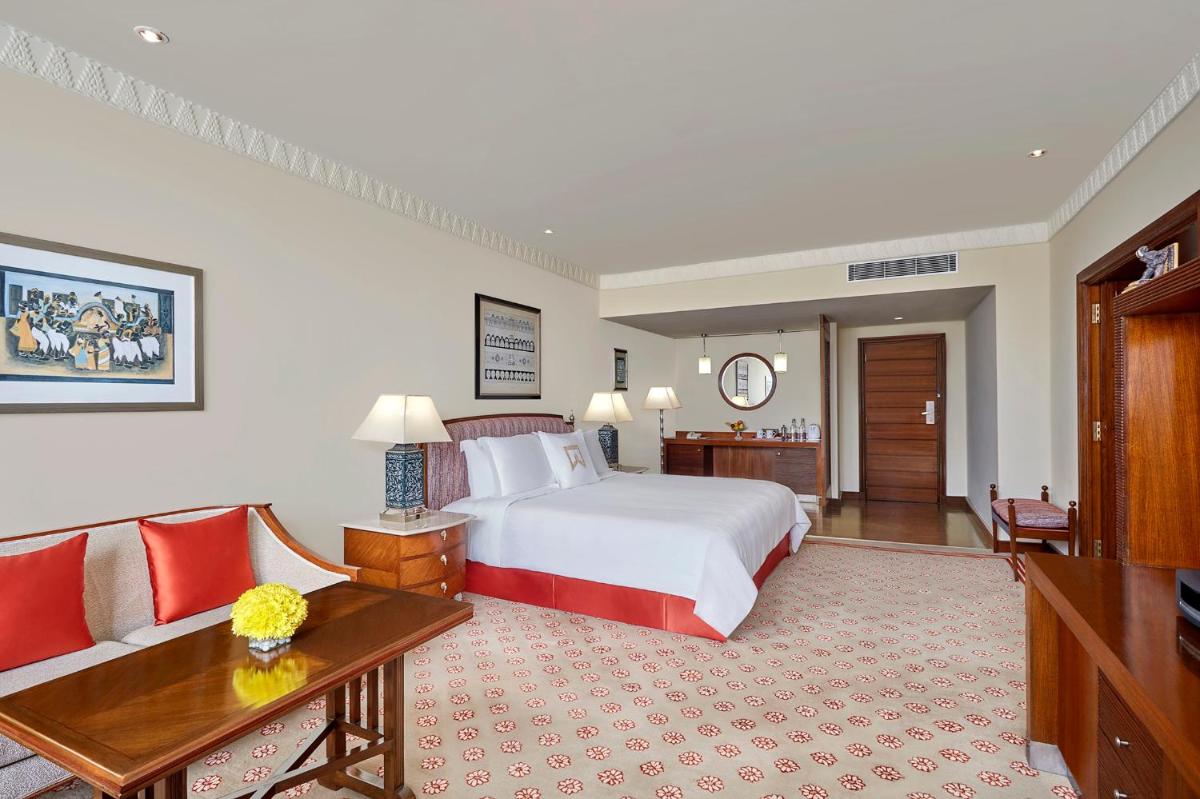 a hotel room with a bed and a couch at ITC Kakatiya, a Luxury Collection Hotel, Hyderabad in Hyderabad