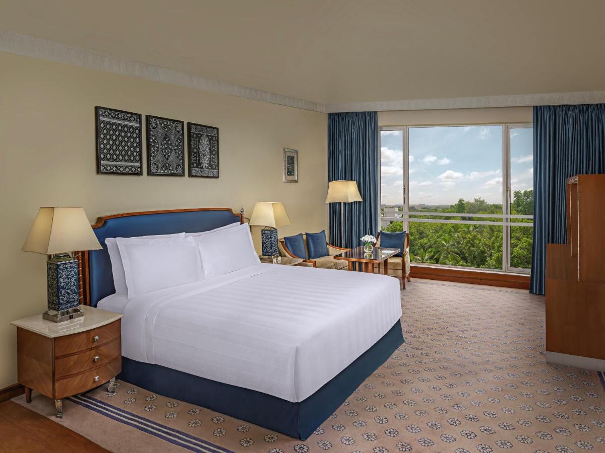 a hotel room with a bed and a large window at ITC Kakatiya, a Luxury Collection Hotel, Hyderabad in Hyderabad