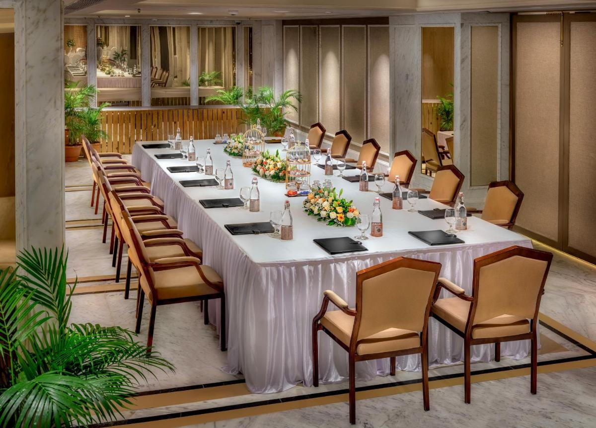 a long table in a room with chairs at ITC Kakatiya, a Luxury Collection Hotel, Hyderabad in Hyderabad