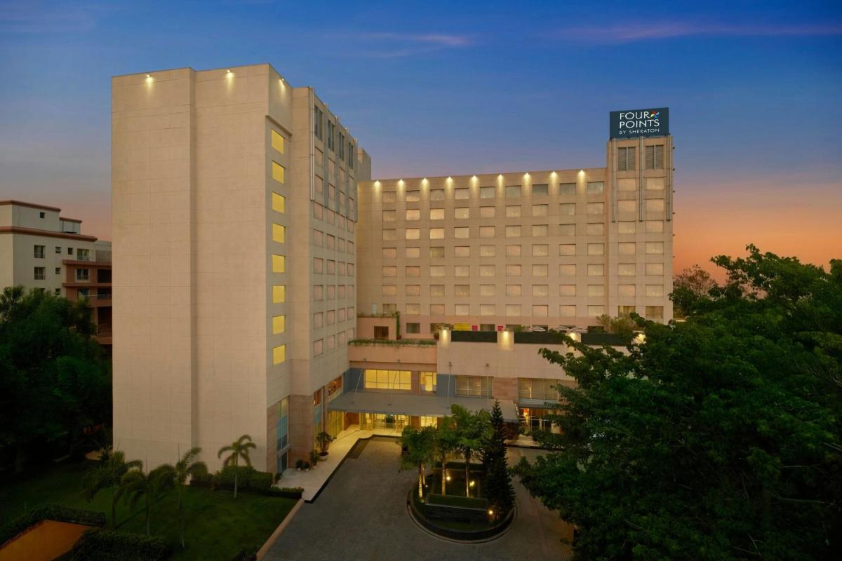 a large white building with a hotel at Four Points by Sheraton Hotel and Serviced Apartments Pune in Pune