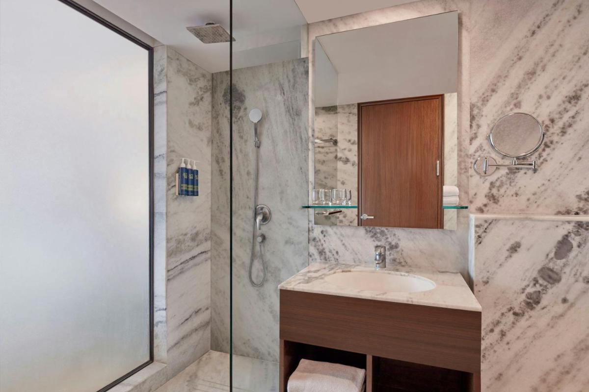 a bathroom with a sink and a shower at Four Points by Sheraton Hotel and Serviced Apartments Pune in Pune