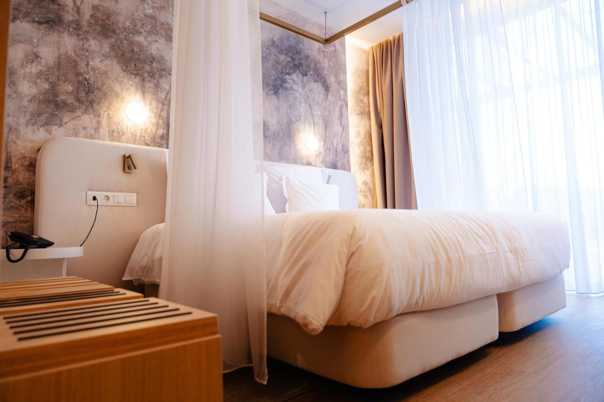 Uma cama ou camas num quarto em Lisotel - Hotel & Spa