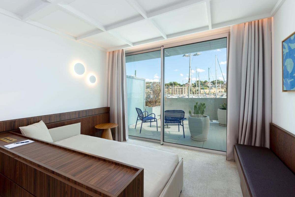 Un ou plusieurs lits dans un hébergement de l'établissement Bleu Hôtel & Spa
