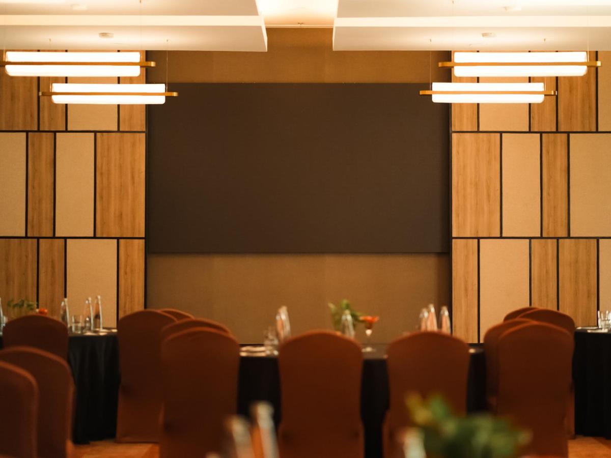 a conference room with tables and chairs and lights at Hyatt Place Gurgaon Udyog Vihar in Gurgaon