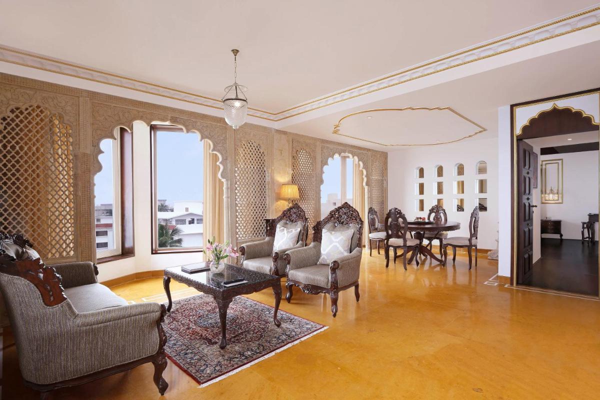 a large living room with chairs and a table at Novotel Mumbai Juhu Beach in Mumbai