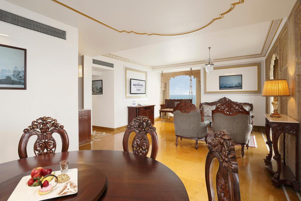 a dining room with a table and chairs at Novotel Mumbai Juhu Beach in Mumbai