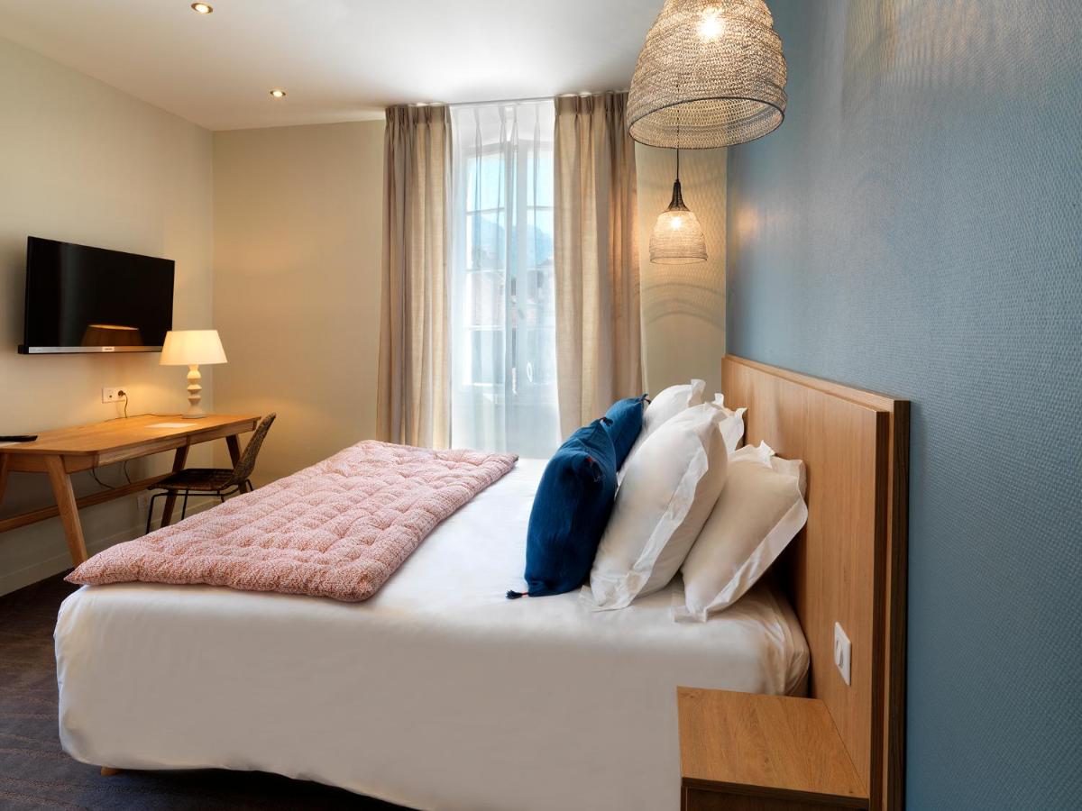 Un ou plusieurs lits dans un hébergement de l'établissement Hôtel Beau Site Talloires B SPA